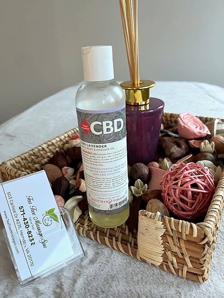 Lavender massage oil and aromatherapy diffuser in a treatment room